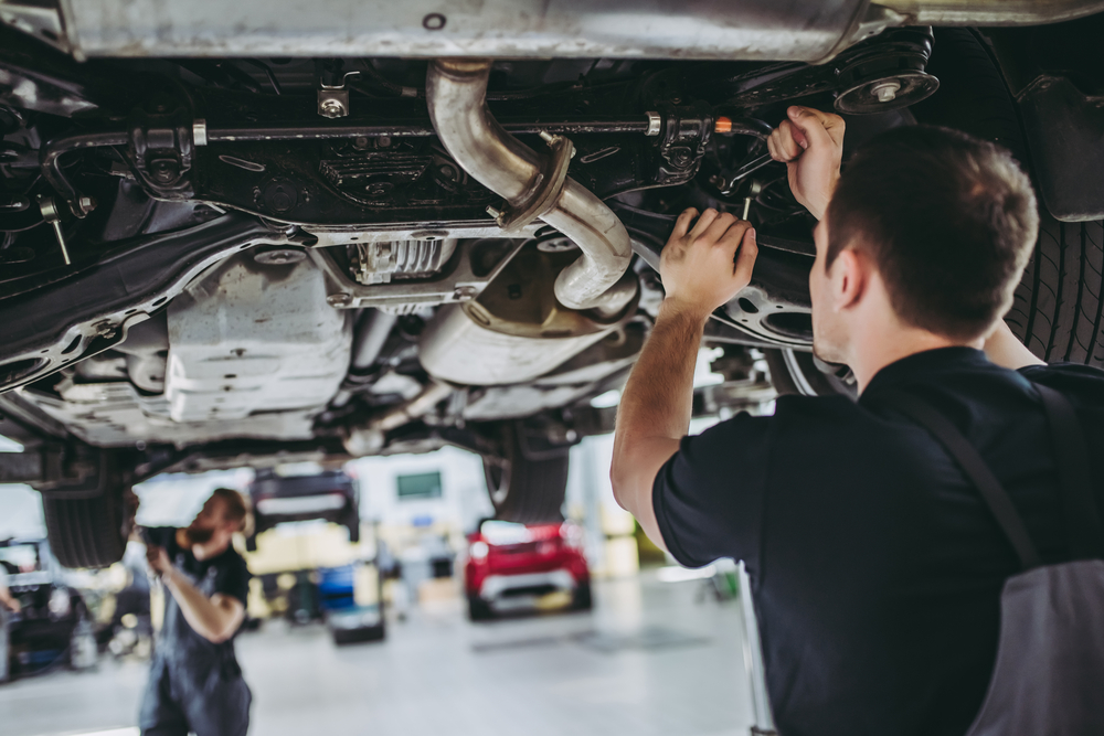 ASE certified mechanics repairing a car